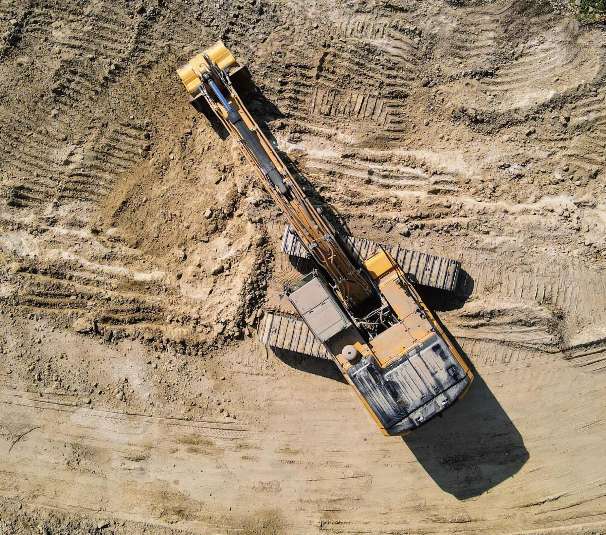 Aerial view of excavator performing earthworks