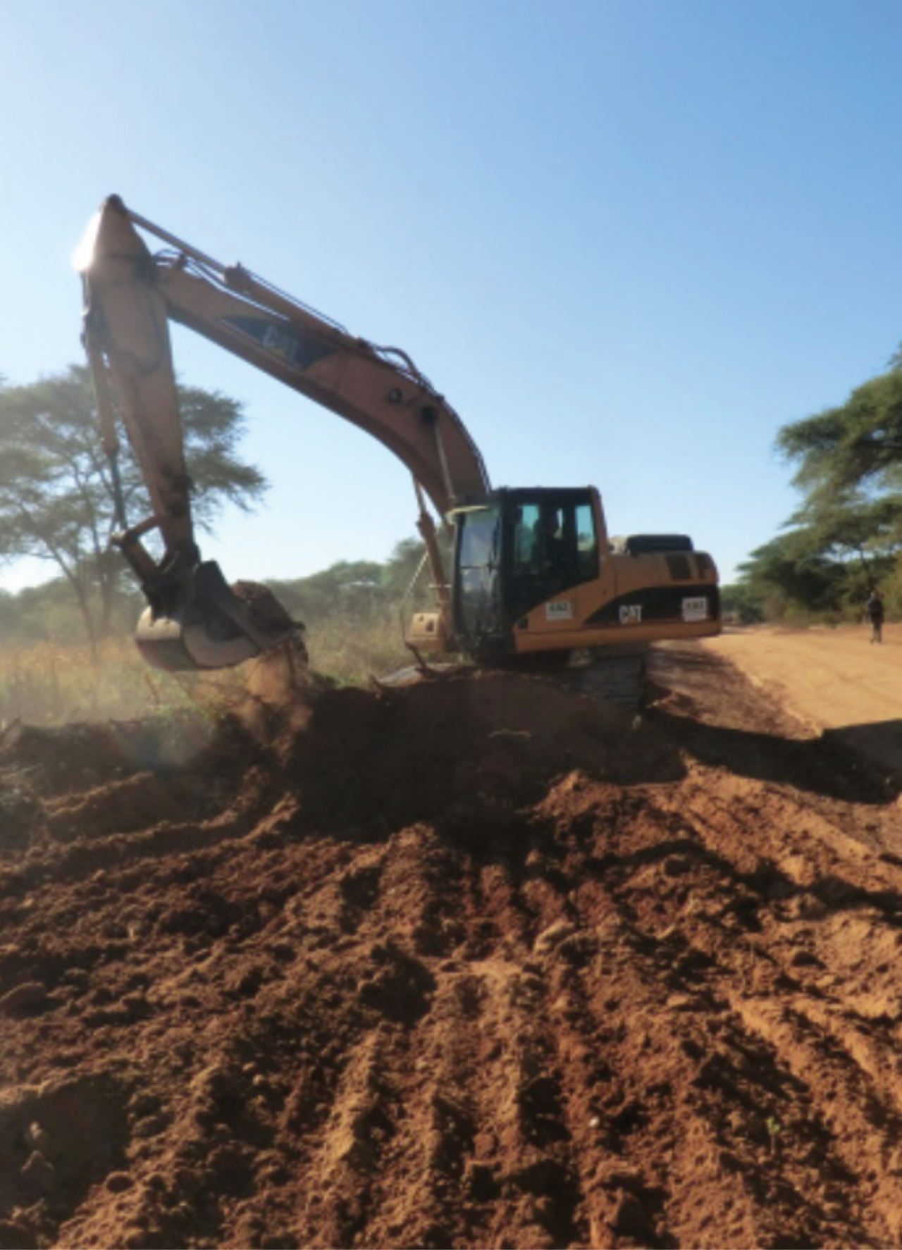 Excavator digging in African landscape